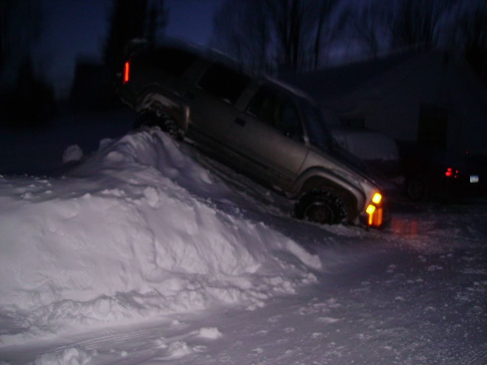 2000 Chevrolet Tahoe stuck in a snowdrift at night