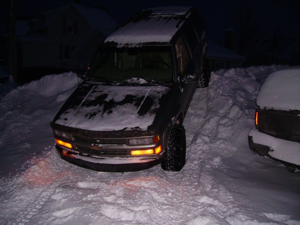 Dark 2000 Chevrolet Tahoe in snow, front 3/4 view