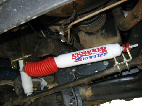 1989 Ford Bronco - Close-up of a Skyjacker Hydro 7000 steering stabilizer installed on a vehicle's suspension.