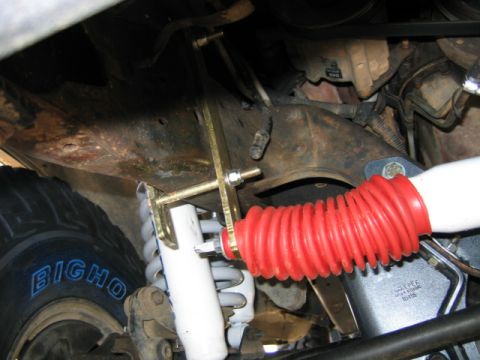 1989 Ford Bronco - This image shows a close-up view of the suspension system, including a steering stabilizer boot and shock absorber.