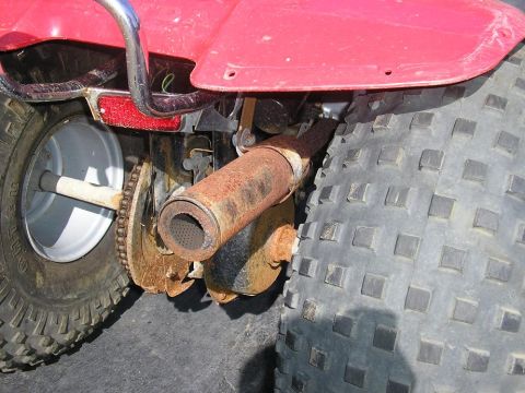 1900 Honda Big Red - Rear view of an ATV showing the axle, chain drive, and exhaust system.