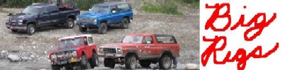 1978 Ford Bronco - Several off-road vehicles are parked together on a gravelly surface.