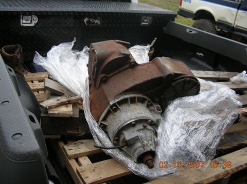1991 Ford F-150 - Transfer case for sale, wrapped in plastic and loaded onto a truck bed with pallets.