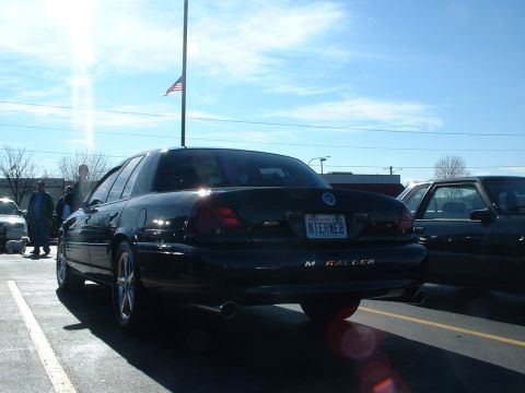 2000 Ford Crown Victoria - Rear view of a black sedan, identified by its 'Marauder' badge and custom license plate, parked in a lot.