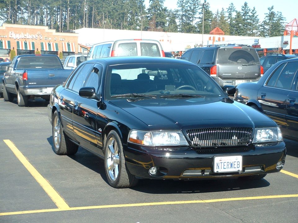 Black 2000 Ford Crown Victoria parked in a lot, front quarter view