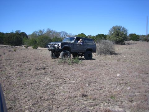 1996 Ford Bronco - Modified 1996 Ford Bronco sits in a field under a clear blue sky.