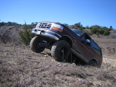 1996 Ford Bronco - This 1996 Ford Bronco navigates a steep, dry, grassy incline.
