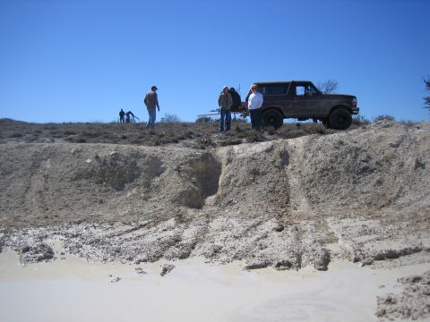 1996 Ford Bronco - 1996 Ford Bronco on a dirt hill with a clear blue sky overhead.
