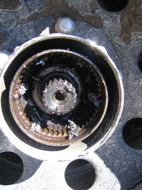1996 Ford Bronco - The wheel hub assembly shows significant damage, with broken metal pieces visible inside.