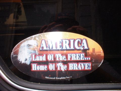 1979 Ford Bronco - A patriotic sticker an eagle and American pride slogans is affixed to a vehicle's window.