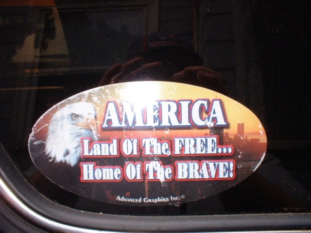 Oval sticker with eagle and text 'AMERICA Land Of The FREE... Home Of The BRAVE!'