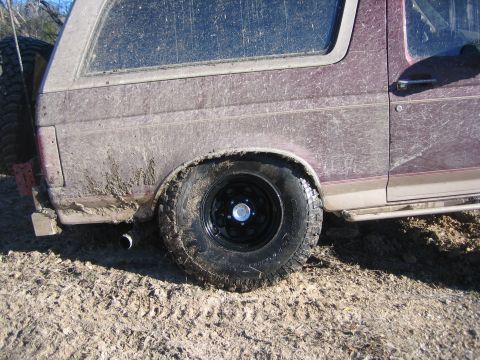 1996 Ford Bronco - This mud-covered 1996 Ford Bronco shows its rear quarter panel and tire, suggesting it has been used off-road.