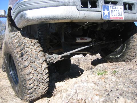 1996 Ford Bronco - The underside of a 1996 Ford Bronco is shown with large off-road tires and a Texas license plate.