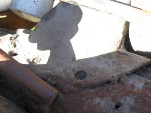 1974 Ford F-100 - A close-up view of a heavily rusted metal frame component, likely from a vehicle's chassis.