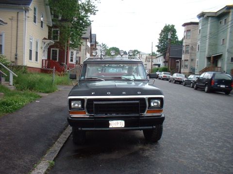 1979 Ford Bronco - This 1979 Ford Bronco is parked on a street lined with houses and other vehicles.