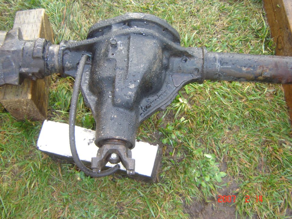 Rear axle assembly on grass, supported by wood blocks