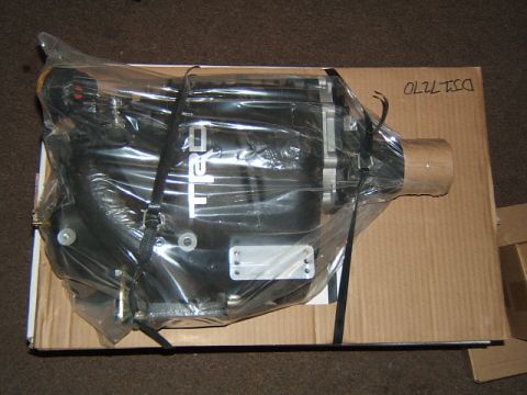 1988 Ford Bronco - A TRD supercharger is shown packaged in plastic wrap on top of a cardboard box.