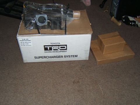 1988 Ford Bronco - A Toyota TRD Supercharger System box is shown on the floor next to other cardboard boxes.