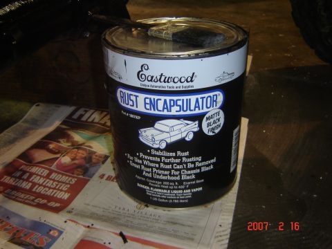 1993 Ford Bronco - A can of Eastwood Rust Encapsulator matte black finish paint sits on a newspaper, with a brush resting on its lid.