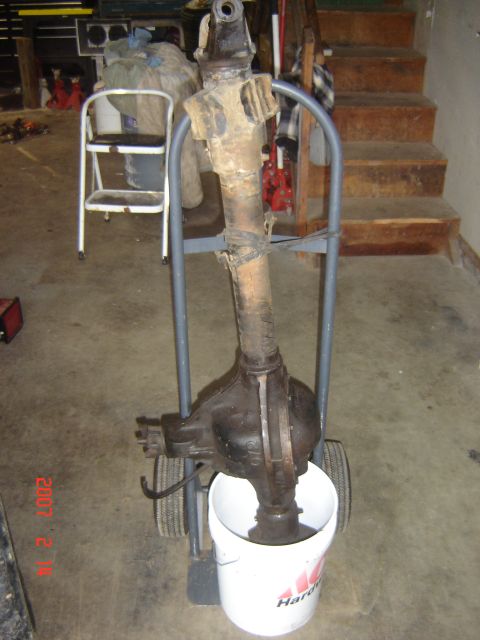 1993 Ford Bronco - Rear axle assembly, likely from a Ford truck or SUV, is being moved on a dolly.
