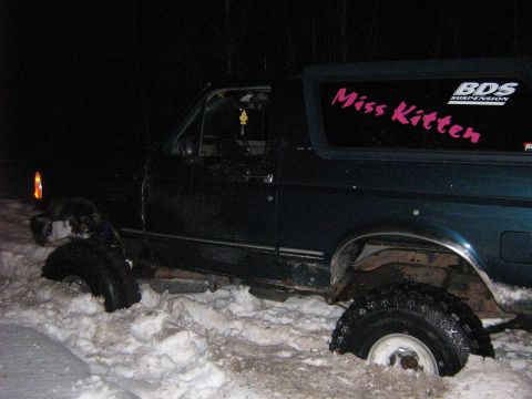 1995 Ford Bronco - This 1995 Ford Bronco is stuck in deep snow, with a custom 'Miss Kitten' sticker visible on the rear window.