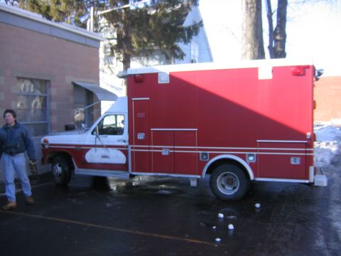 1984 Ford F-350 - This ambulance truck has a white cab and a large red body with storage compartments.