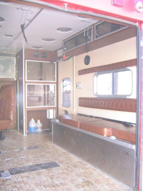 1984 Ford F-350 - The interior of a vehicle, possibly an ambulance, shows seating and storage compartments.
