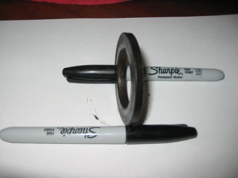 1991 Ford Bronco - Two Sharpie markers and a metal washer are shown on a white surface.