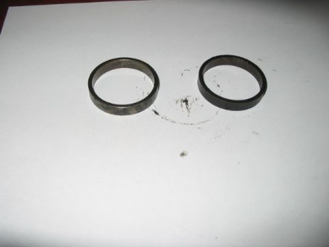 1991 Ford Bronco - Two metal rings are shown on a white background, possibly automotive parts.