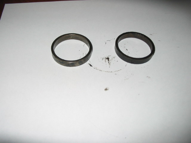 Two metal rings on a white surface