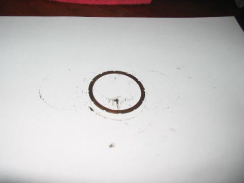 1991 Ford Bronco - A circular oil stain is visible on a white surface, with some smudged marks around it.