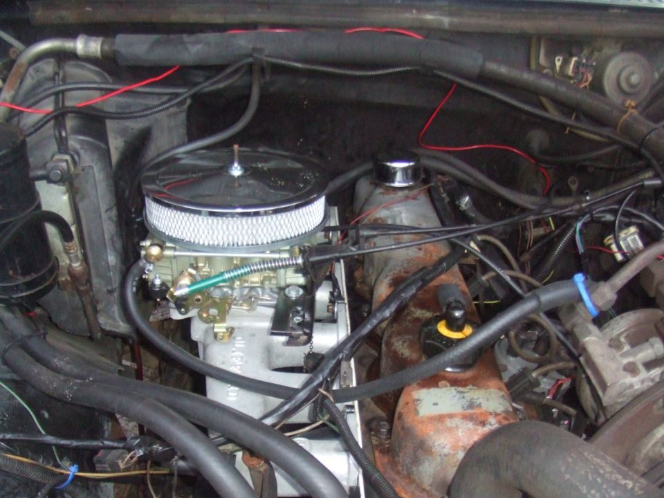 Engine bay with aftermarket carburetor and air filter