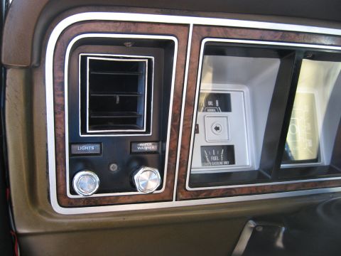 1979 Ford Bronco - Interior view of a 1979 Ford Bronco dashboard, wood-grain trim, air vents, and instrument cluster details.
