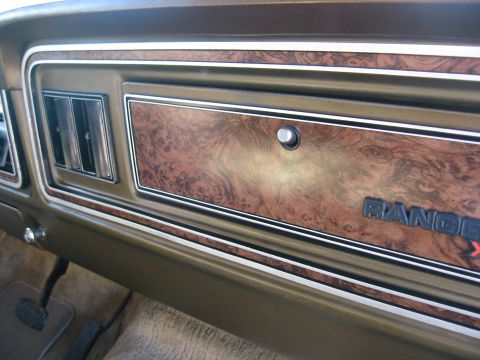 1979 Ford Bronco - Interior view of a dashboard with woodgrain trim and 'RANGER XLT' badging, likely from the late 1970s.