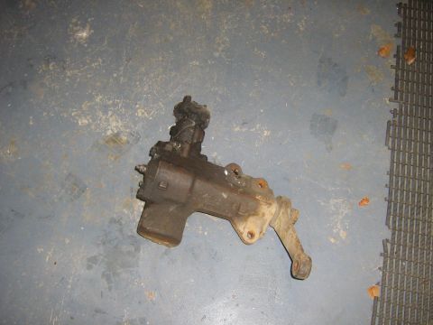 1995 Ford Bronco - A steering gear box part is shown on a grey floor with a black matting in the background.