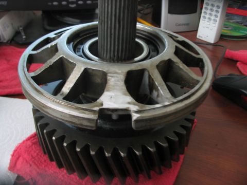1991 Ford Bronco - A transmission pump with a splined shaft sits atop a large gear, resting on a red cloth.