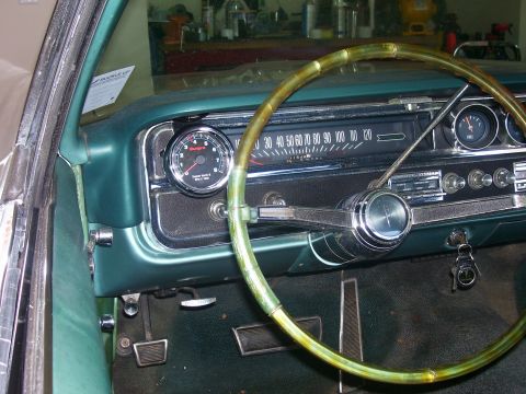 1965 Pontiac Catalina - The interior of a 1965 Pontiac Catalina shows its dashboard, steering wheel, and an aftermarket tachometer.
