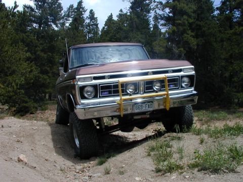 1979 Ford Bronco - This 1975 Ford F-Series truck features a prominent yellow brush guard and appears to be modified for off-road use.