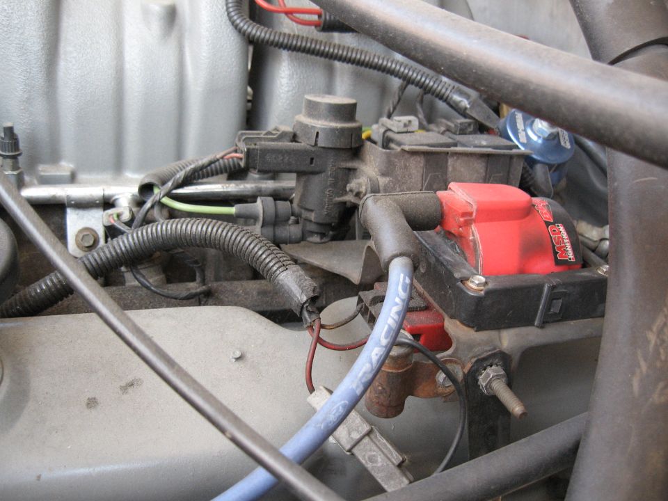 Engine bay with red MSD ignition coil and blue spark plug wire