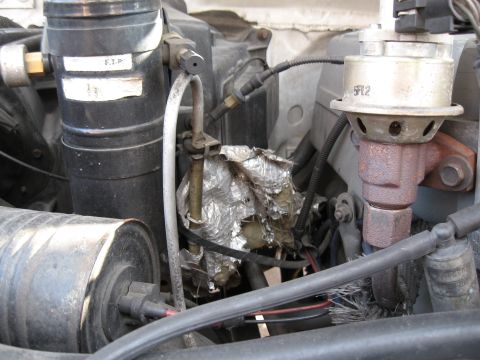 1994 Ford Bronco - This image shows various engine components, including a label with 'F.T.P.' and a part marked '5F12'.
