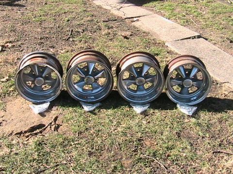 1973 Ford Ranchero - A set of four chrome five-spoke wheels are displayed outdoors on the grass.