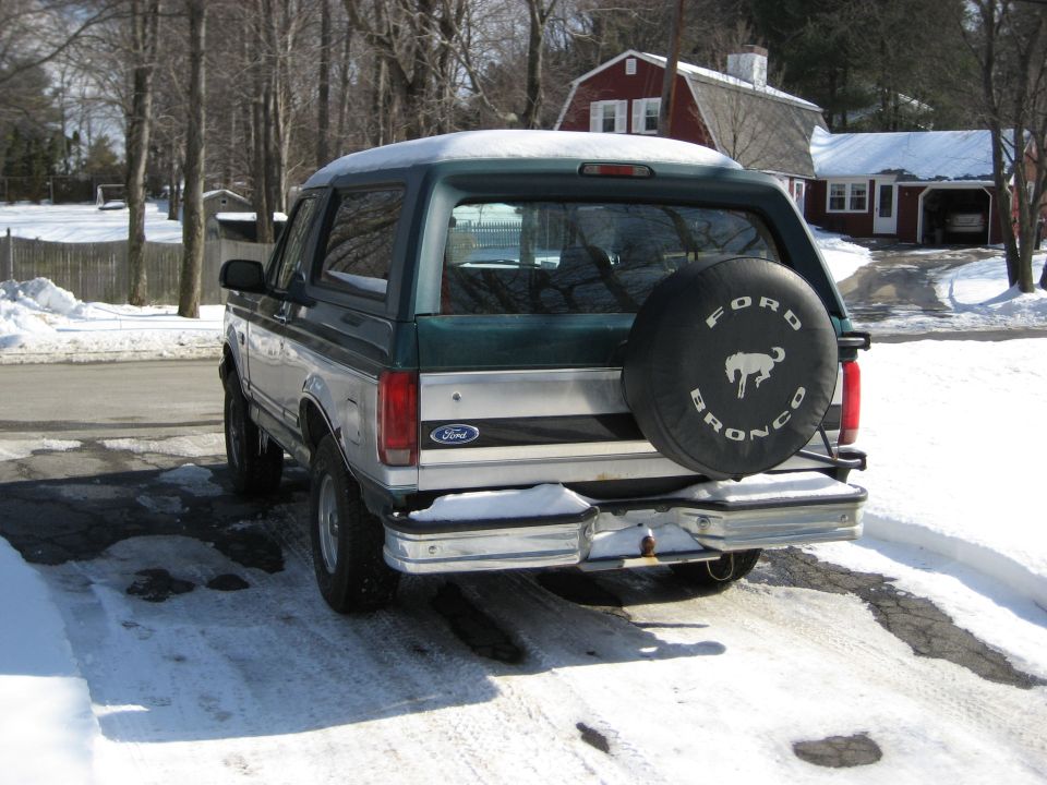 1994 Ford Bronco rear view with spare tire cover. Green and silver paint