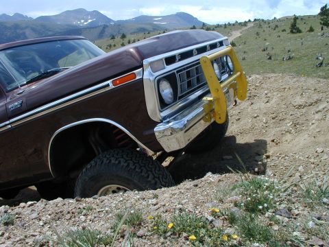 1979 Ford Bronco - Ford Bronco on a dirt trail with mountains in the background.