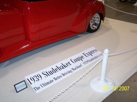 1979 Ford F-150 - A red 1939 Studebaker Coupe Express is displayed at a show, custom wheels and a lowered stance.