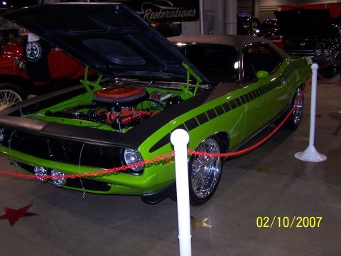 1979 Ford F-150 - Lime green muscle car with hood open, displaying its engine and chrome wheels.