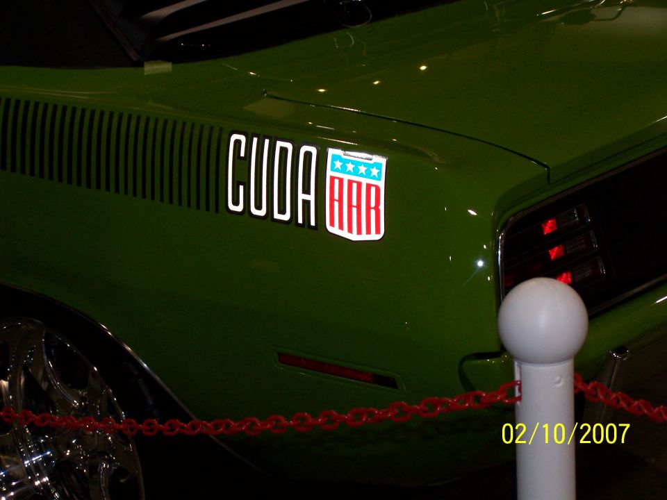 Green Plymouth Barracuda with 'CUDA' and AAR decal on the fender