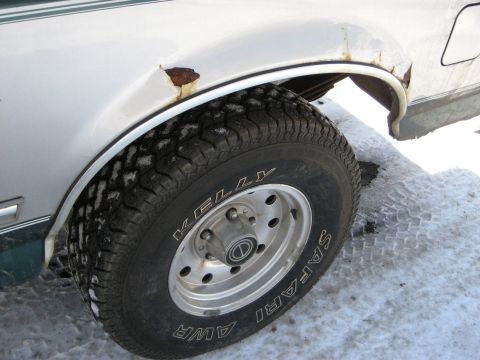 1994 Ford Bronco - This 1994 Ford Bronco shows significant rust around the rear wheel well, with a Kelly Safari AWR tire visible.