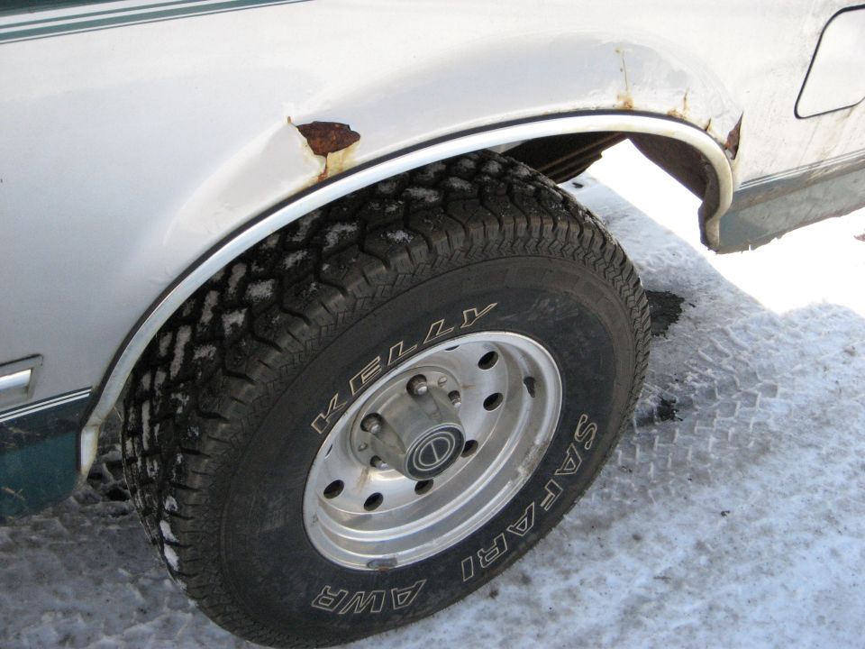1994 Ford Bronco side view, showing rust on rear wheel well and Kelly Safari AWR tire