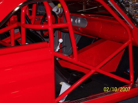 1979 Ford F-150 - Interior view of a red race car, showing the roll cage and dashboard details.