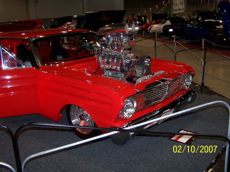 Red hot rod with exposed chrome supercharger and custom grille
